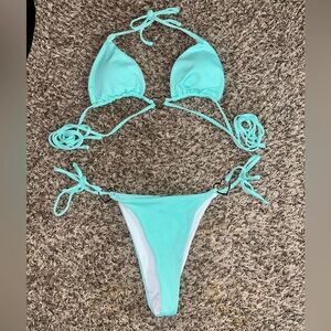 Cute and sexy, teal, multi string bikini with metal heart charms on hips & chest